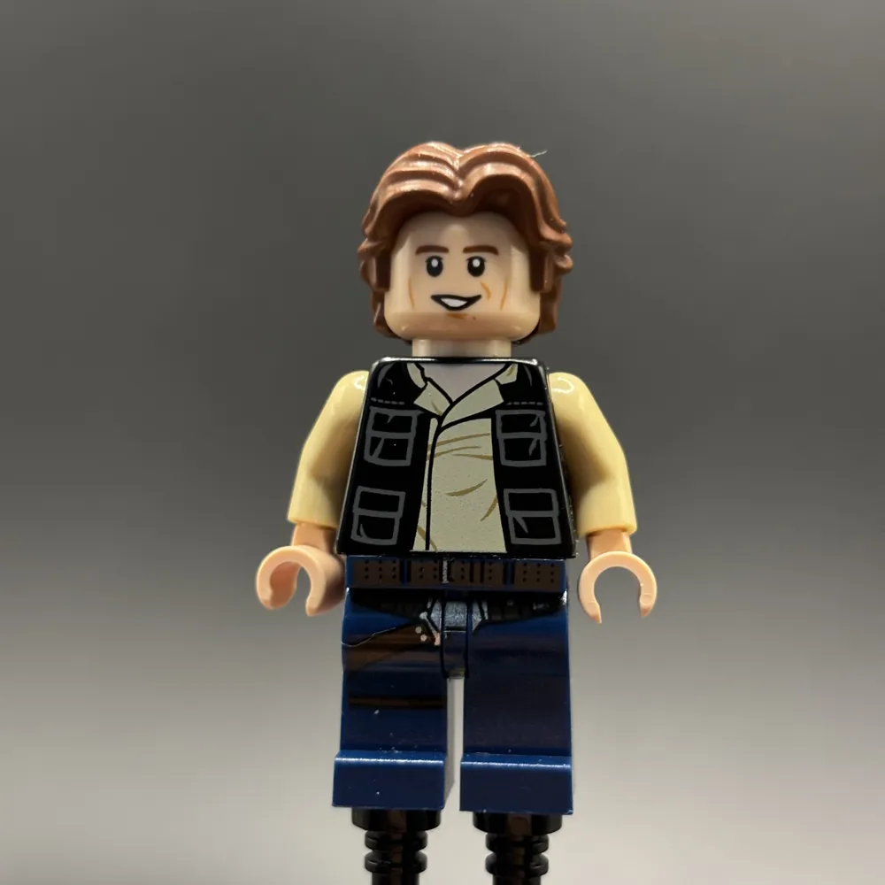 Han Solo - Black Vest with Pockets over Tan Shirt with Dark Tan Creases, Dark Blue Legs with Belts, Wavy Hair